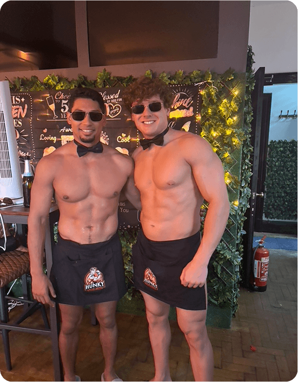 Two buff butlers posing together at a hen party event